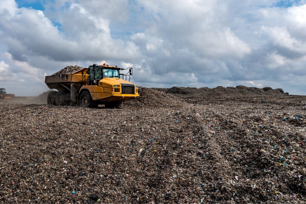 Dumper truck unloading on landfill site